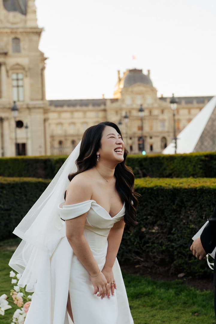 Nancy laughing during the vows of their Paris elopement ceremony