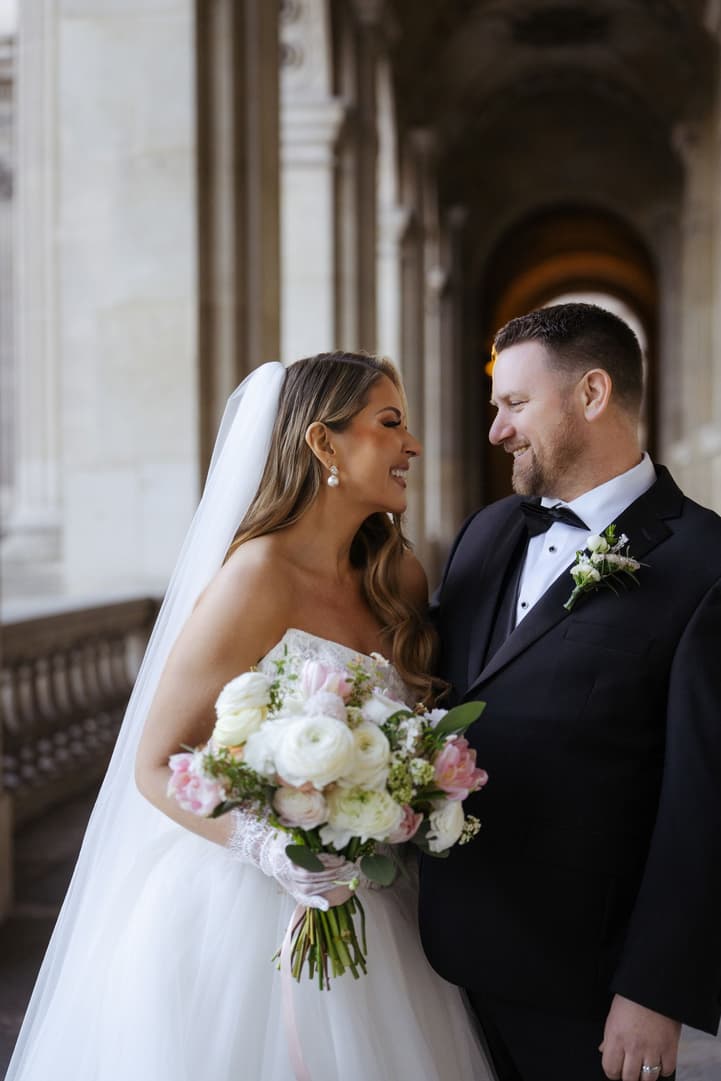 Aphrodite and Michael laughing together after their first look at the Louvre