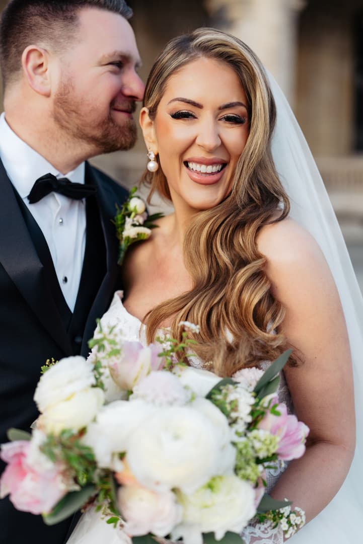 Aphrodite laughing with Michael, her bouquet in her arms, at the Louvre