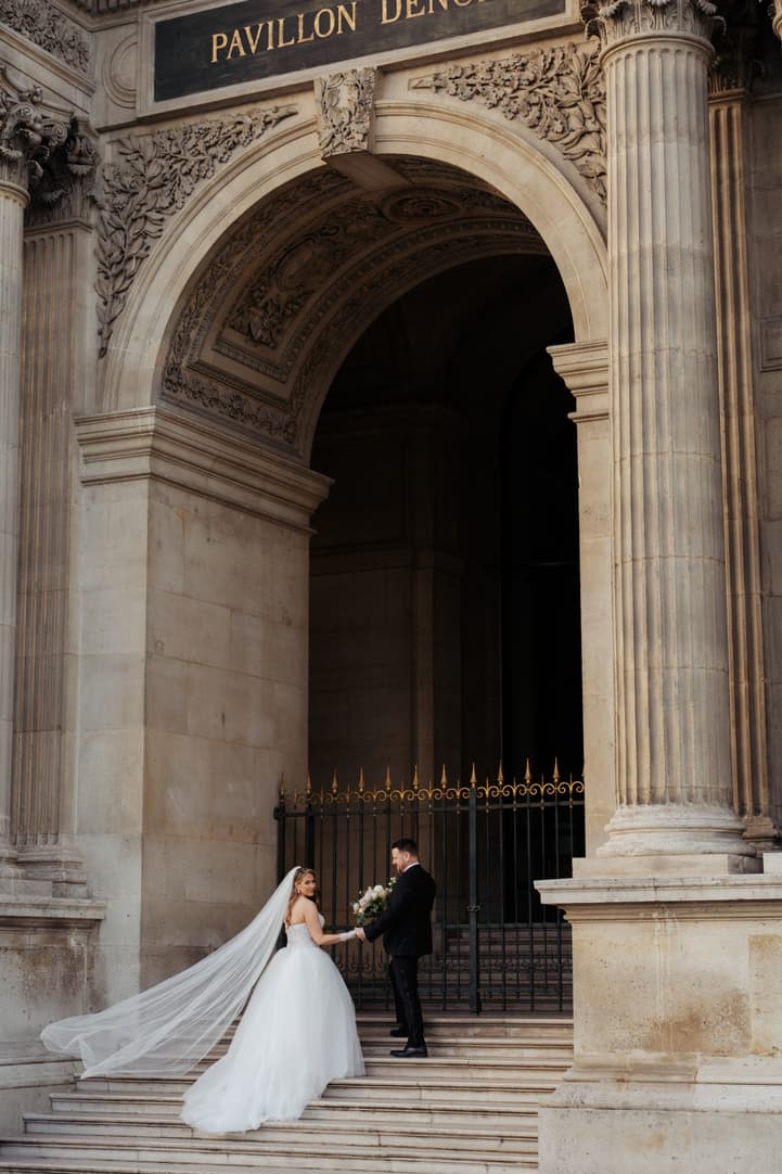 Aphrodite's veil flying on the steps of the Pavillon Denon at the Louvre