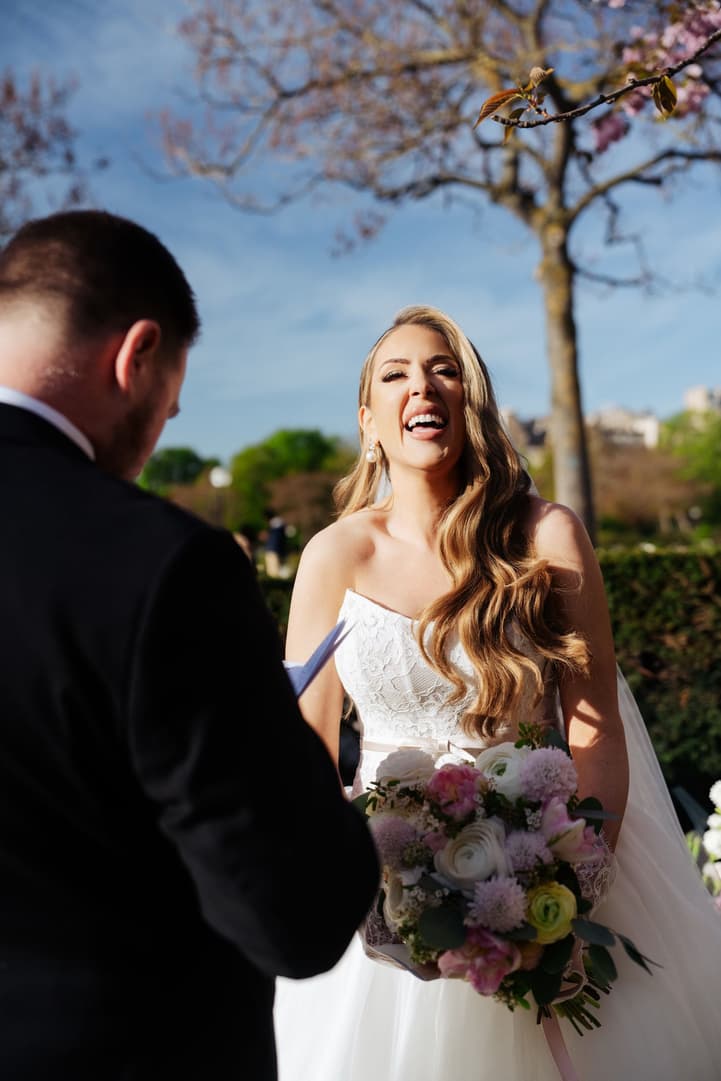 Aphrodite laughing as Michael reads his vows