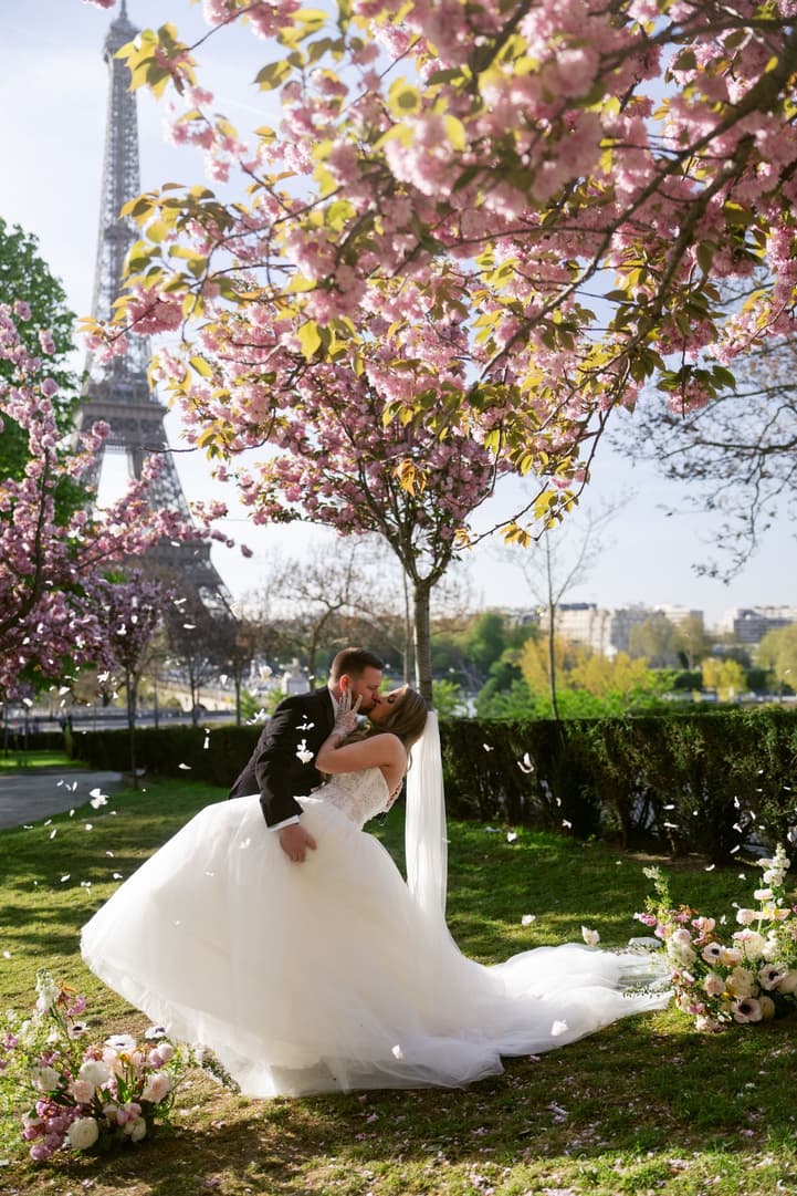 Michael dipping Aphrodite for a kiss under the cherry blossoms