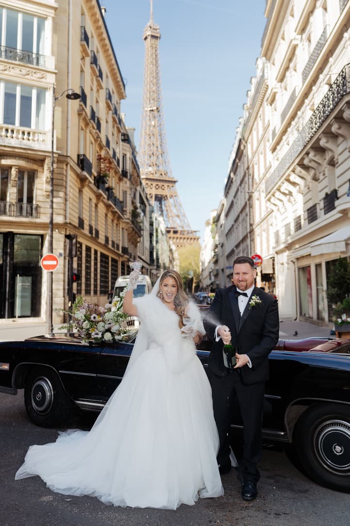 Champagne spraying on a Paris street with the Eiffel Tower at its end
