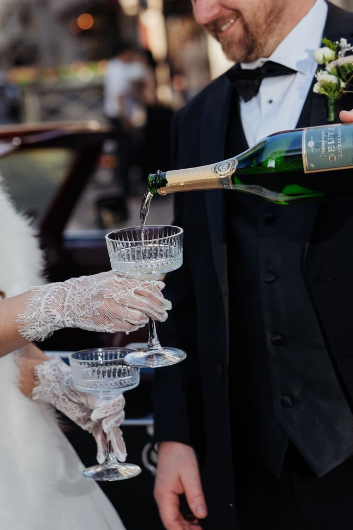 Michael pouring champagne into Aphrodite's coupe