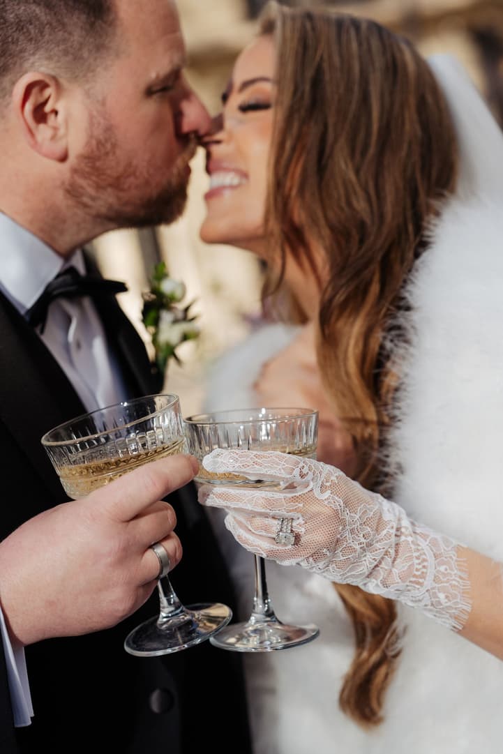 Aphrodite and Michael toasting with crystal coupes