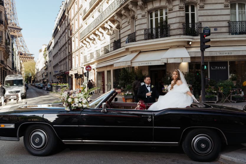 The black vintage convertible on a Paris street corner, Aphrodite and Michael inside