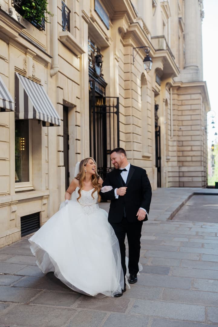 Aphrodite and Michael walking arm in arm down a Paris street