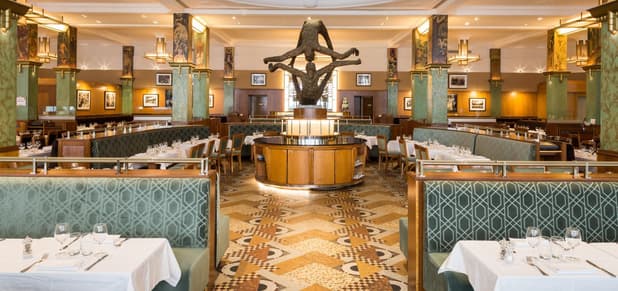 The Art Deco dining room of La Coupole, its painted pillars and banquettes