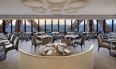 The dining room of Le Jules Verne inside the Eiffel Tower, its windows on Paris