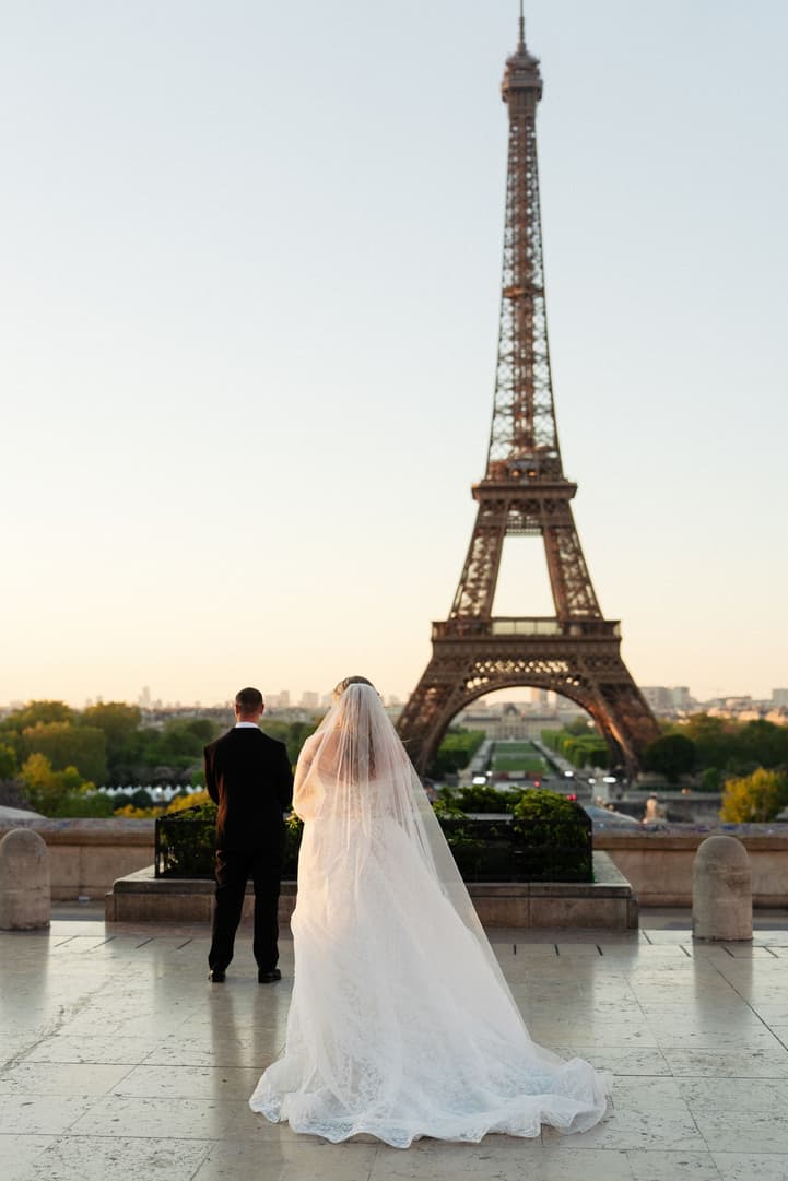 Tyler waits with his back turned on the Trocadéro as Victoria walks up behind him for their first look