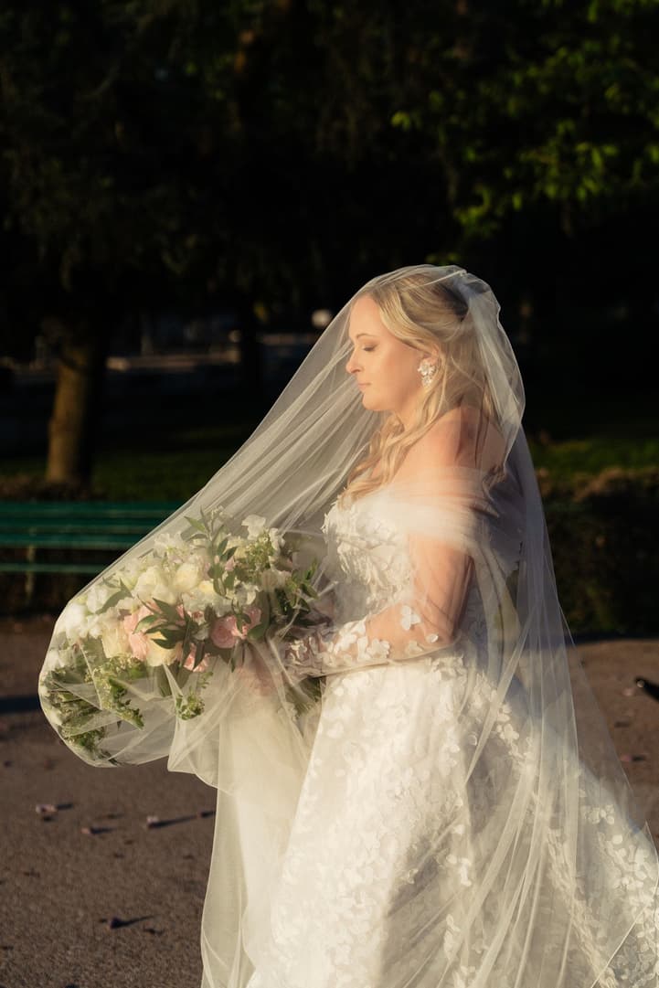 Victoria under her veil with her bouquet, moments before walking to her ceremony in the Trocadéro gardens