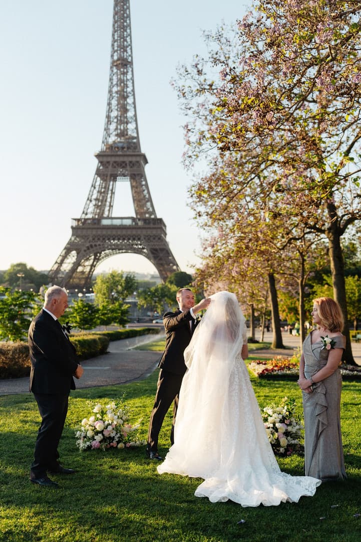 Victoria and Tyler together at the start of their ceremony in the Trocadéro gardens, their family watching