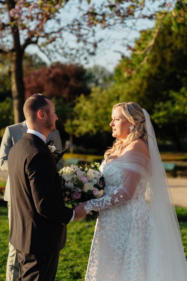 Victoria and Tyler hold hands during their personal vows in the Trocadéro gardens