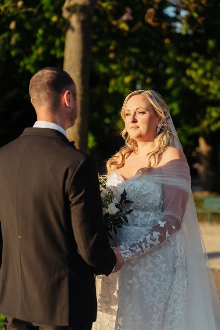 Victoria looks at Tyler as she reads her personal vows in the morning sun of the Trocadéro gardens