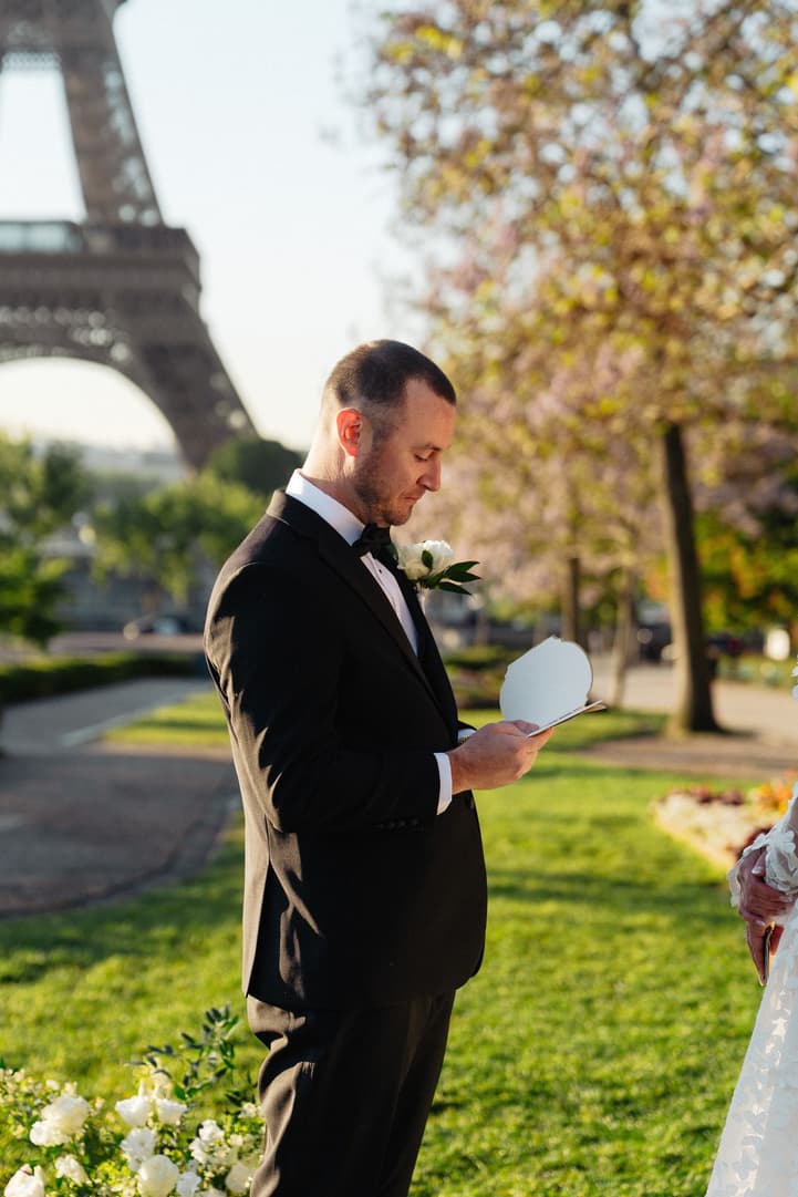 Tyler reads from his vow book during his Paris elopement ceremony in the Trocadéro gardens