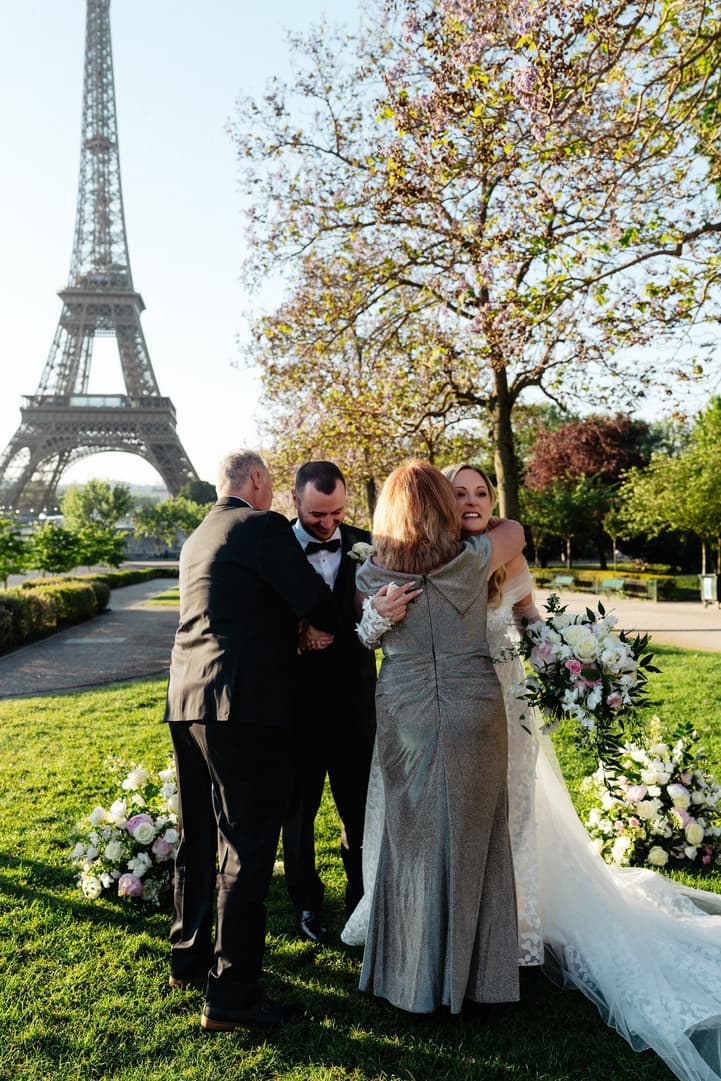 Their family hugs Victoria and Tyler after their ceremony in the Trocadéro gardens