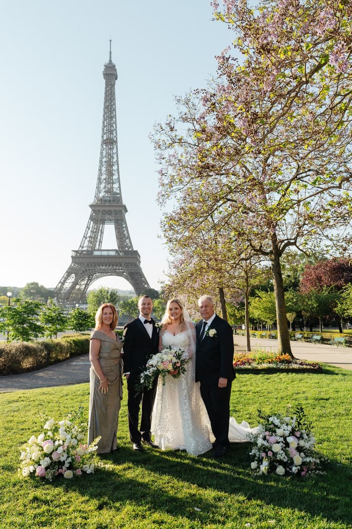 Victoria and Tyler with their family after their Paris elopement, the Eiffel Tower behind
