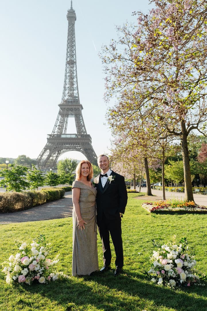 Tyler with one of their family guests in the Trocadéro gardens after the ceremony, the Eiffel Tower behind