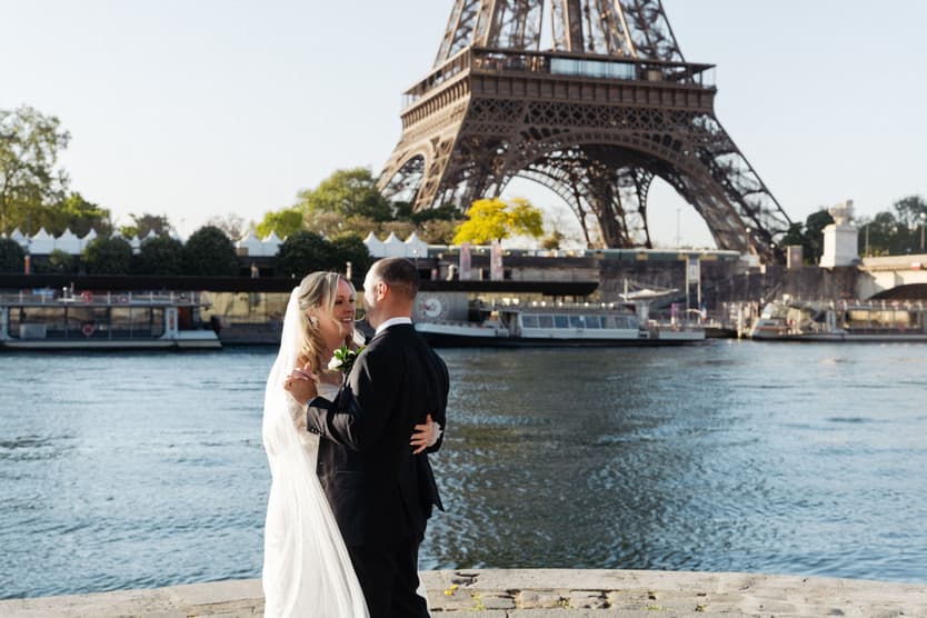 Victoria and Tyler dance by the Seine after their Paris elopement, the Eiffel Tower across the river