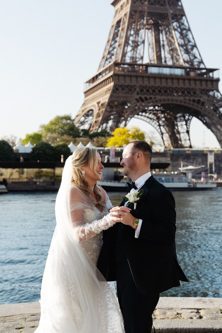 Victoria and Tyler smile at each other during their first dance by the Seine