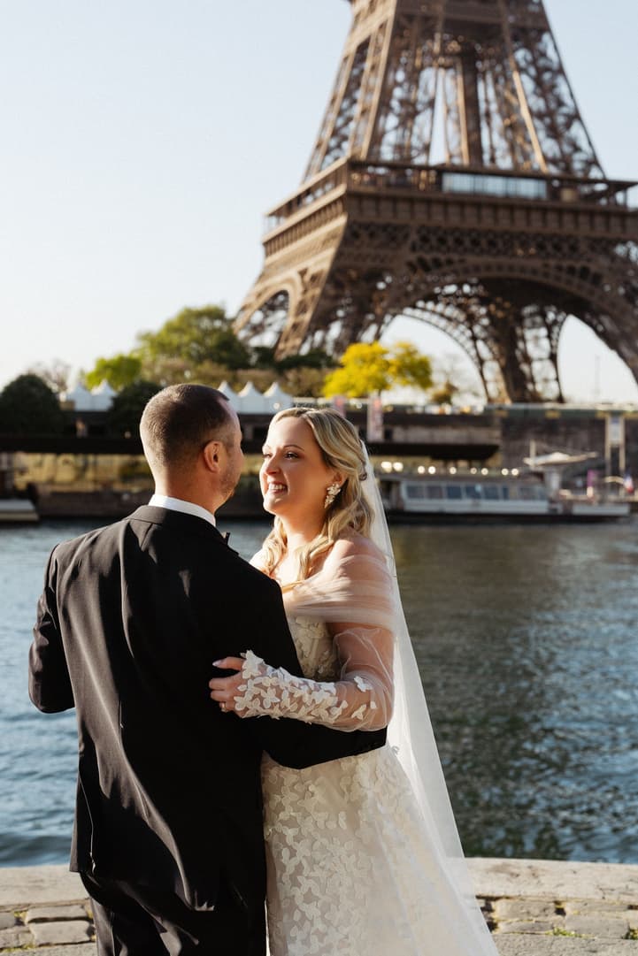 Tyler holds Victoria close during their first dance on the bank of the Seine, the Eiffel Tower above