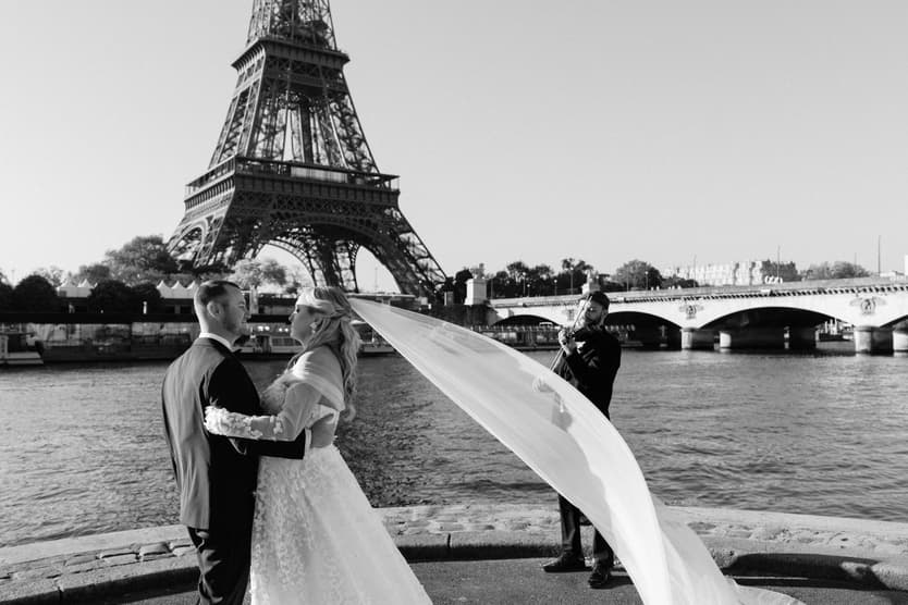 Black and white: Victoria's veil flies out as she dances with Tyler by the Seine, the violinist playing