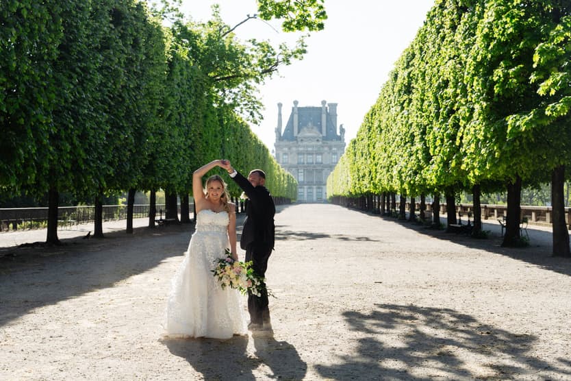 Tyler twirls Victoria in her wedding gown in an allée of the Tuileries Garden