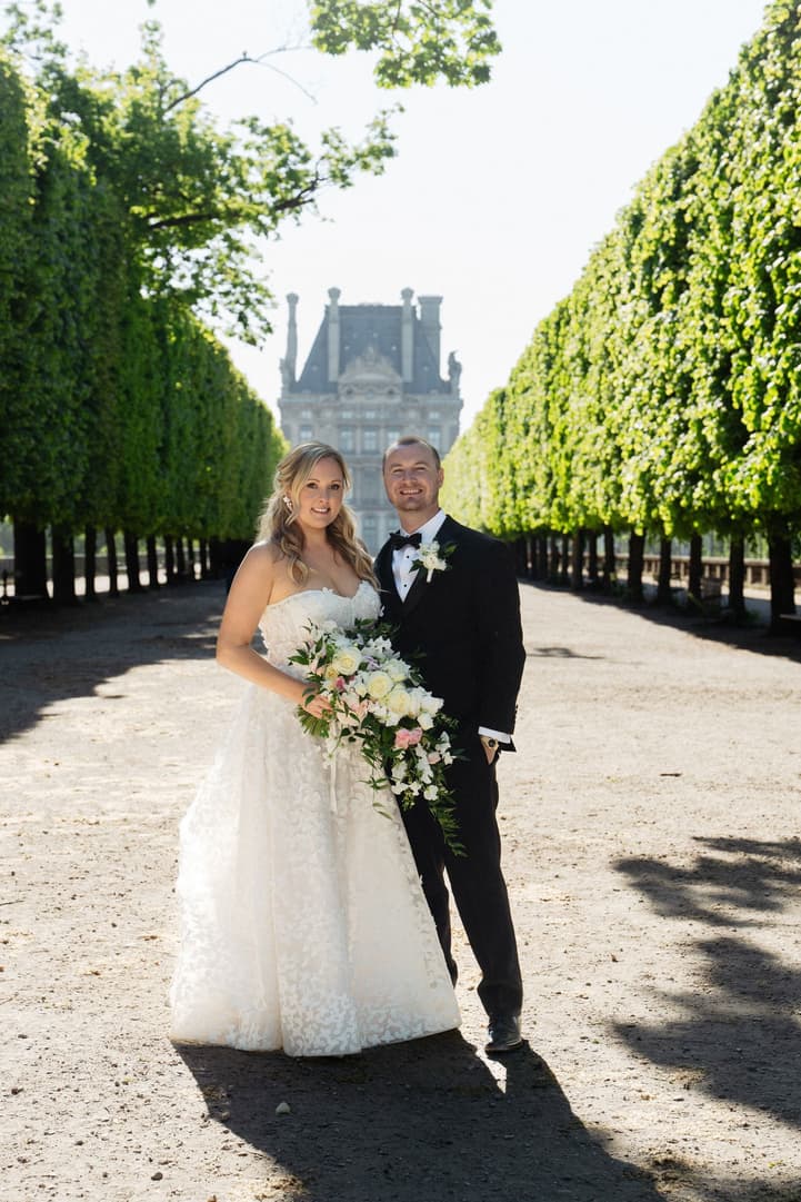 Victoria and Tyler in the spring shade of the Tuileries' clipped trees, the Louvre behind